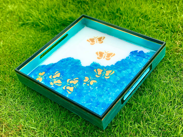 Golden butterflies in blue waves tray