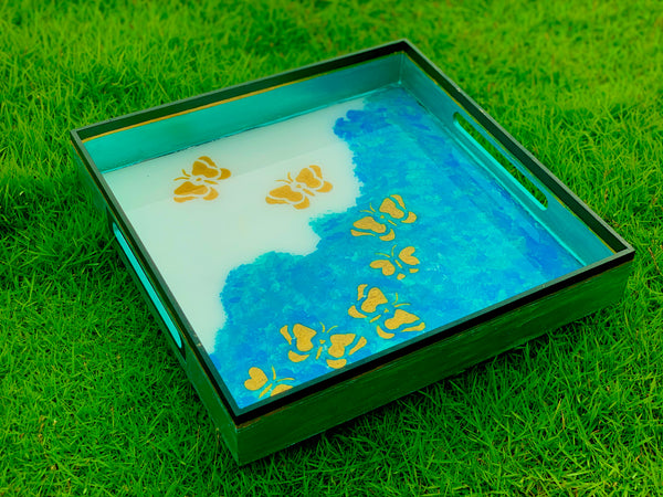 Golden butterflies in blue waves tray